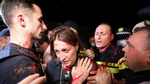 Opposition activists scuffle with police during a rally, following the death of a cameraman who was beaten up during violence against LGBT activists last week