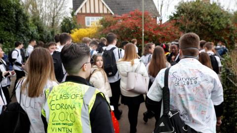 Pupils leave a school in Odiham, west London, on Friday.
