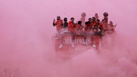 The Liverpool parade bus entirely surrounded with red smoke on 26 May 2025