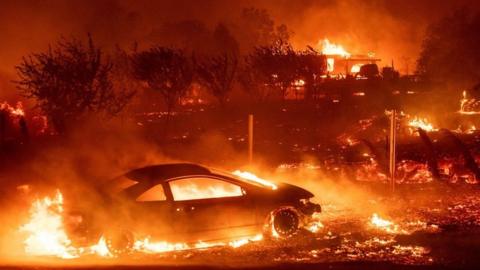 Vehicles and homes burn as the Camp fire tears through Paradise, California