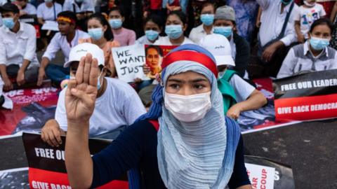 A protester in Myanmar's main city, Yangon, demonstrates against the coup, 22 February 2021