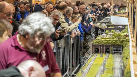 People at a model train exhibition