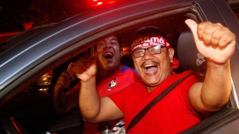Two Panama fans celebrate their country's World Cup qualification
