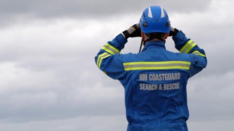 Coastguard rescuer looks out to sea