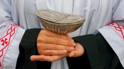 Stock image of a young member of the church's hands