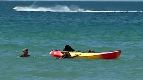 President Marcelo Rebelo de Sousa helps two women in the water