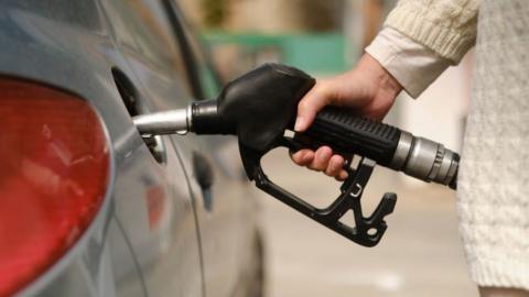 Woman putting fuel in car