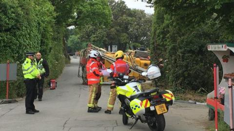 Emergency services at the scene of the overturned tractor