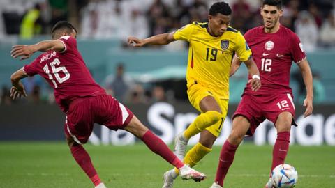 Karim Boudiaf and Boualem Khoukhi of Qatar with Gonzalo Plata of Ecuador in action during the FIFA World Cup Qatar 2022