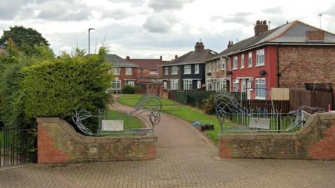 A path leading between a row of houses