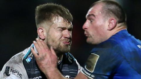 Dan Baker of Ospreys is tackled by Rhys Ruddock