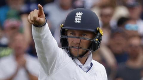 England's Joe Root points to the stands after taking a catch