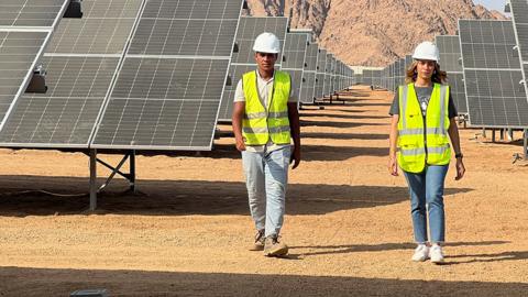 Engineers walk next to solar panels installed near to mountains in Sharm El-Sheikh in Egypt, ahead of the COP27 climate summit in the resort