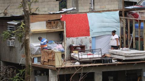 Residents salvage what they can from their home that was destroyed when Hurricane Maria in Corozal, Puerto Rico