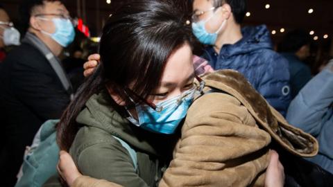 Medical team members heading to Wuhan to reinforce hospitals fighting the coronavirus outbreak bid farewell to family members as they board the train at Nanjing South Railway Station in Nanjing City,