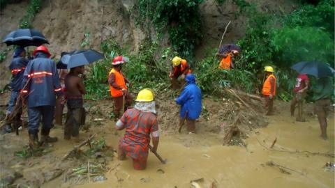 Bangladeshi fire fighters search for bodies after a landslide in Bandarban on 13 June 2017.