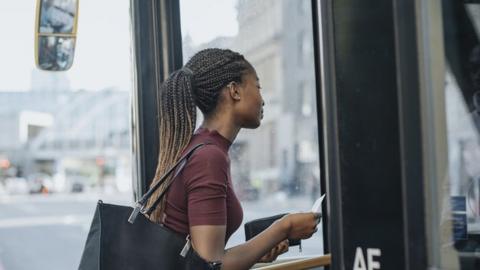 Woman boarding bus