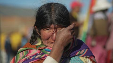 An indigenous woman prays and cries during a blockade to a Yacimientos Petroliferos Fiscales Bolivianos (YPFB) oil refinery