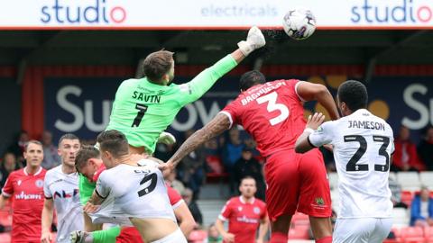 Goalkeeper Toby Savin of Accrington Stanley punches away a free-kick