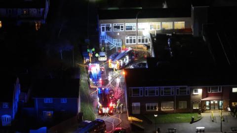 View of fire engines and police dealing with a fire at a school in Hove