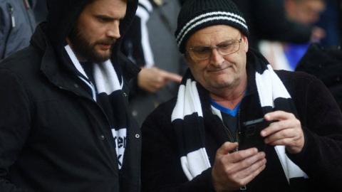 Newcastle United fans checking their phones at 3pm