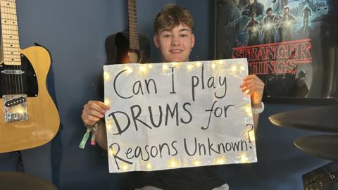 Ozzy holding up his sign