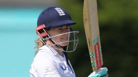 Tammy Beaumont of England Women celebrates reaching her century during the tour match between England Women and Australia A Women at The Incora County Ground on June 16, 2023 in Derby, England.