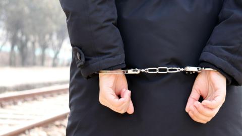 File photo of someone in handcuffs