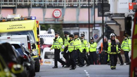 Police and fire services gather at the scene of an incident on the District line in London