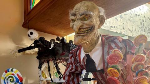 A spooky man holding lollipops - decoration inside the hotel