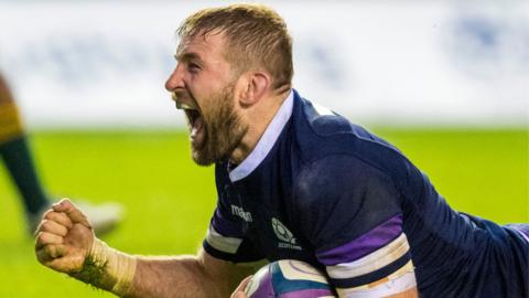 John Barclay celebrates a try with ball in hand