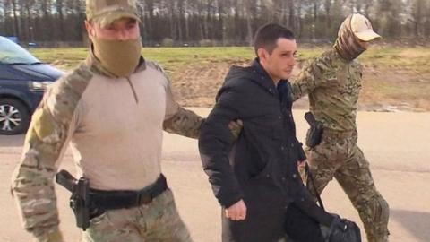 Trevor Reed being escorted to the plane out of Russia on Wednesday