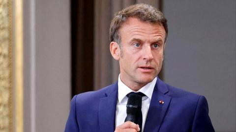 France's President Emmanuel Macron addresses mayors of cities affected by the violent clashes