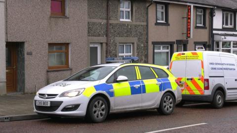 House at Water St, Penygroes with police car and scenes of crime van outside