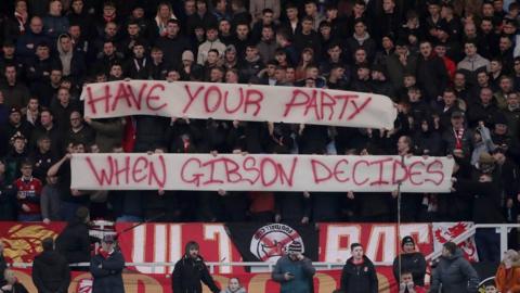 Fans holding banners at the Riverside stadium on Saturday 12 February