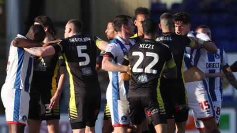 Hartlepool and Sutton players are involved in a melee during their League Two meeting