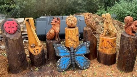 Totems displaying a variety of woodland creatures