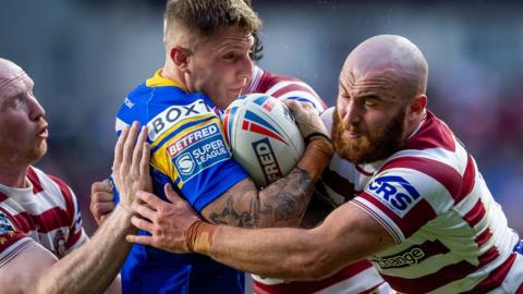 Liam Sutcliffe is tackled by Jake Bibby