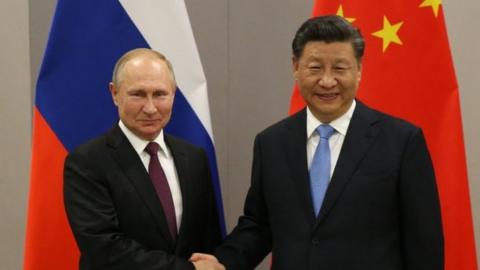 Russian President Vladimir Putin (L) greets Chinese President Xi Jinping (R) during their bilateral meeting on November 13, 2019 in Brasilia, Brazil.