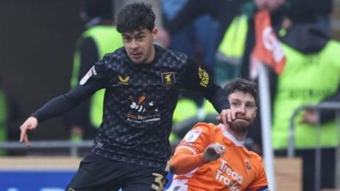 Blackpool's James Husband is fouled by Mansfield Town's Caylan Vickers