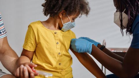 A file image of a child receiving a vaccine