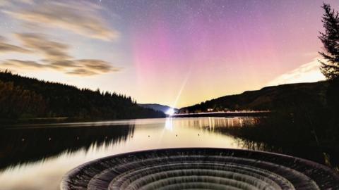 The Northern Lights visible over the Ladybower Reservoir in Derbyshire.