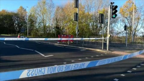 Police tape by road crossing