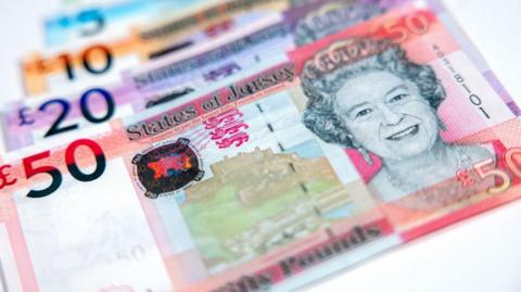 Jersey bank notes ranging from £50 to £5 in a line.