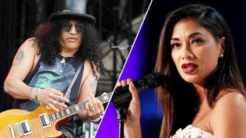 Slash performing on stage with guitar. Nicole Scherzinger holding microphone