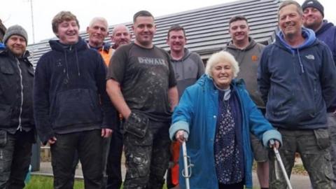 Ann Rowlands with the local traders, and builders merchants who have helped