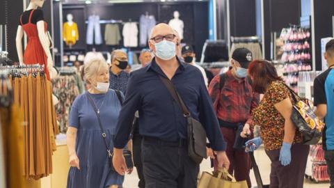 Shoppers wearing masks