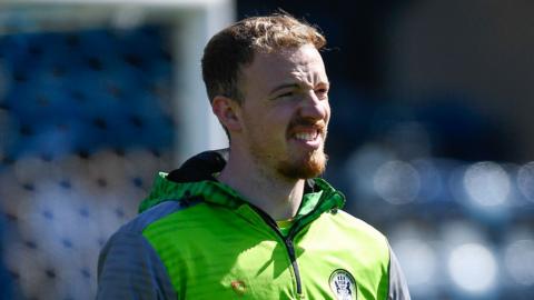 Lewis Thomas warming up before a game for Forest Green last season