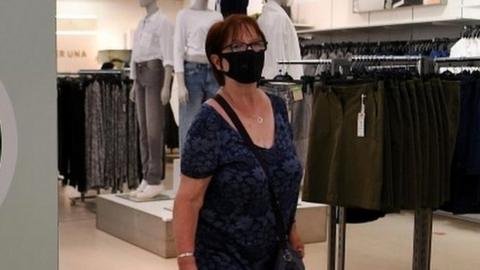 Woman wearing face mask in London shop