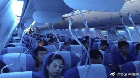 Aircraft passengers with oxygen masks dropped